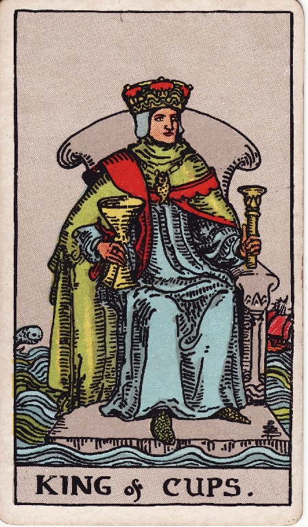 King of cups. This card features a king sitting on a throne holding a cup in one hand. His throne is floating atop sea waters and a ship can be seen in the background.